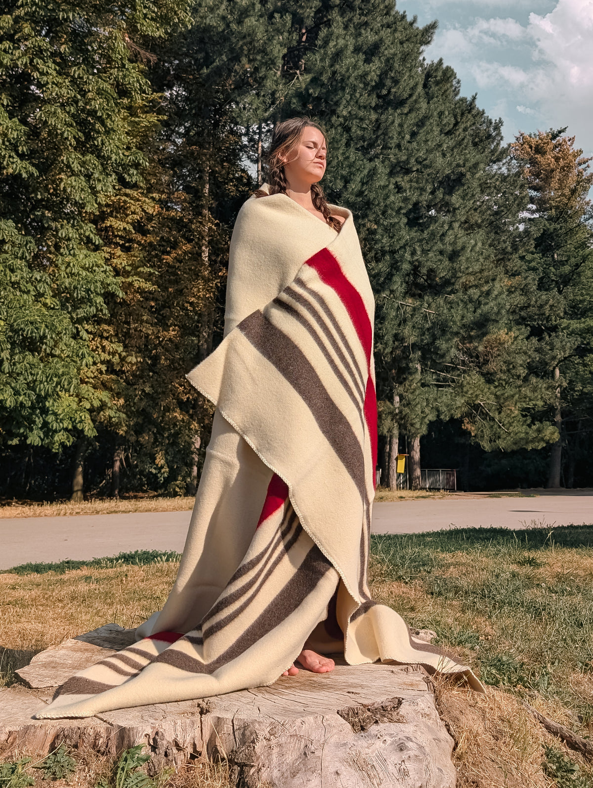A girl wrapped in heritage wool bedspread throw blanket of premium quality. Item best for camping, bedding and home decor.