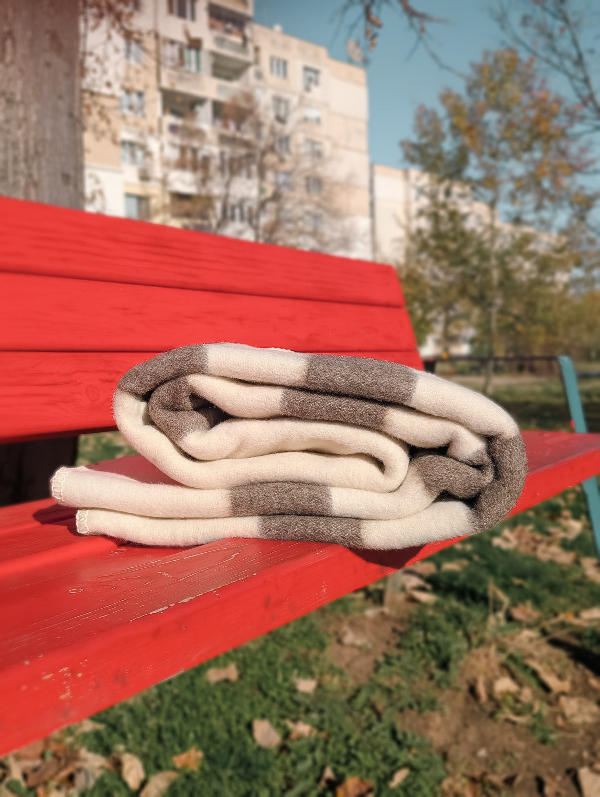 Folded wool striped throw woven from naturally colored Bulgarian wool