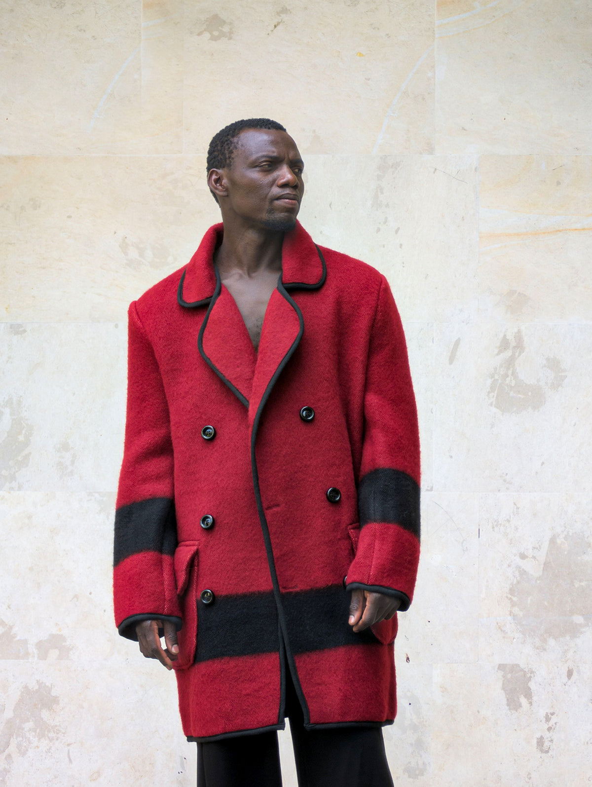 Man wearing designer's limited edition pure wool blanket jacket with double breasted buttoning.