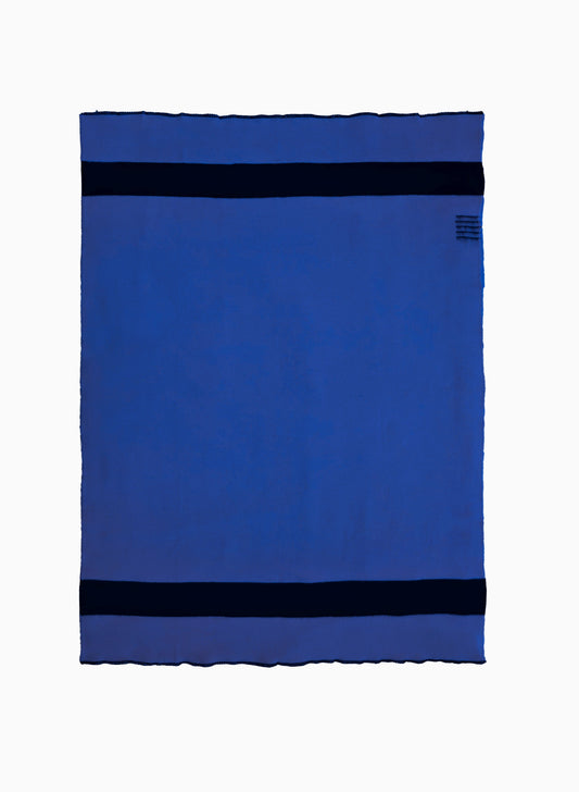 Top-down studio shot of the blue and black Blanket No. 1 virgin wool throw laid flat.