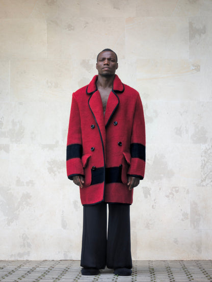Front full-length view of a model wearing a 1960s-1970s red wool blanket jacket with double-breasted buttoning and flap pockets.