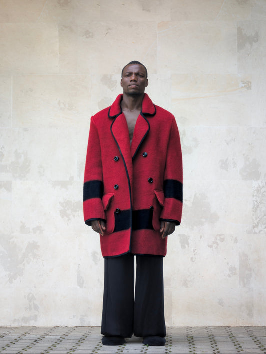 Front full-length view of a model wearing a 1960s-1970s red wool blanket jacket with double-breasted buttoning and flap pockets.