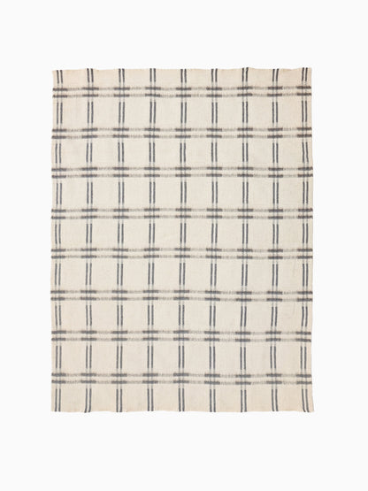 Full view of handwoven undyed wool blanket in natural ivory and taupe with geometric check weave