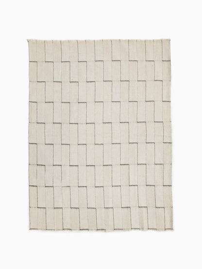 Full view of undyed pure wool blanket with handwoven stepped geometric pattern in natural ivory