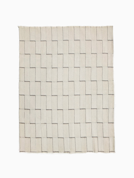 Full view of undyed pure wool blanket with handwoven stepped geometric pattern in natural ivory