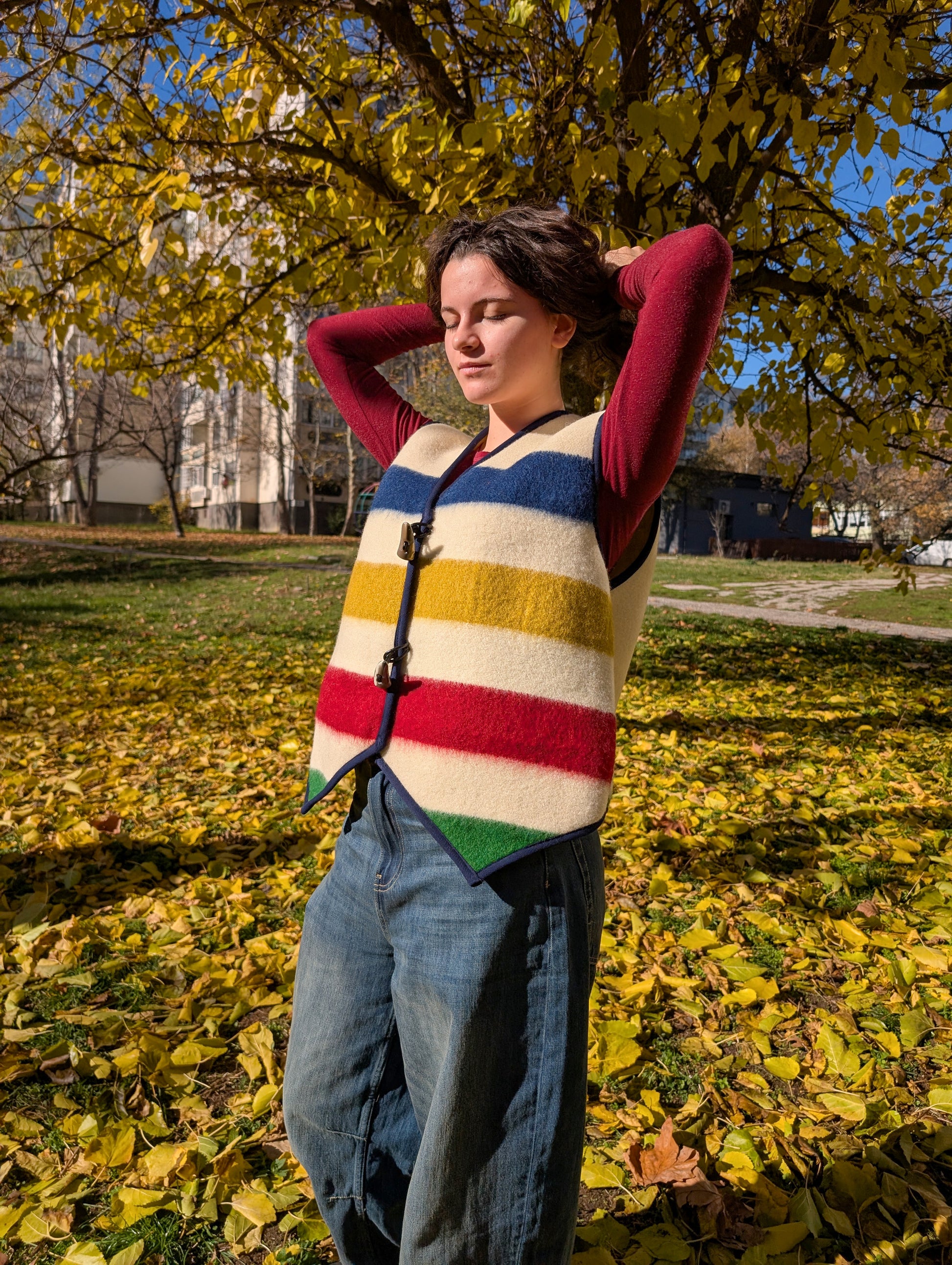 Woman wearing a woolen designers' gilet, upcycled from one of our new handwoven pure wool blankets. Suitable for steet wear, everyday walks, slow fashion statement, reenactment events and more.