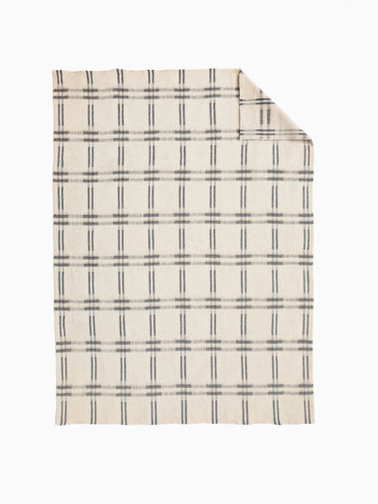 Undyed pure wool throw with handwoven ivory and taupe check. Heavywaight, breathable and hypoallergenic.