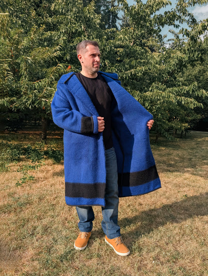 Man wearing blue revolutionary coat, made from traditionally handwoven woolen stripe blanket