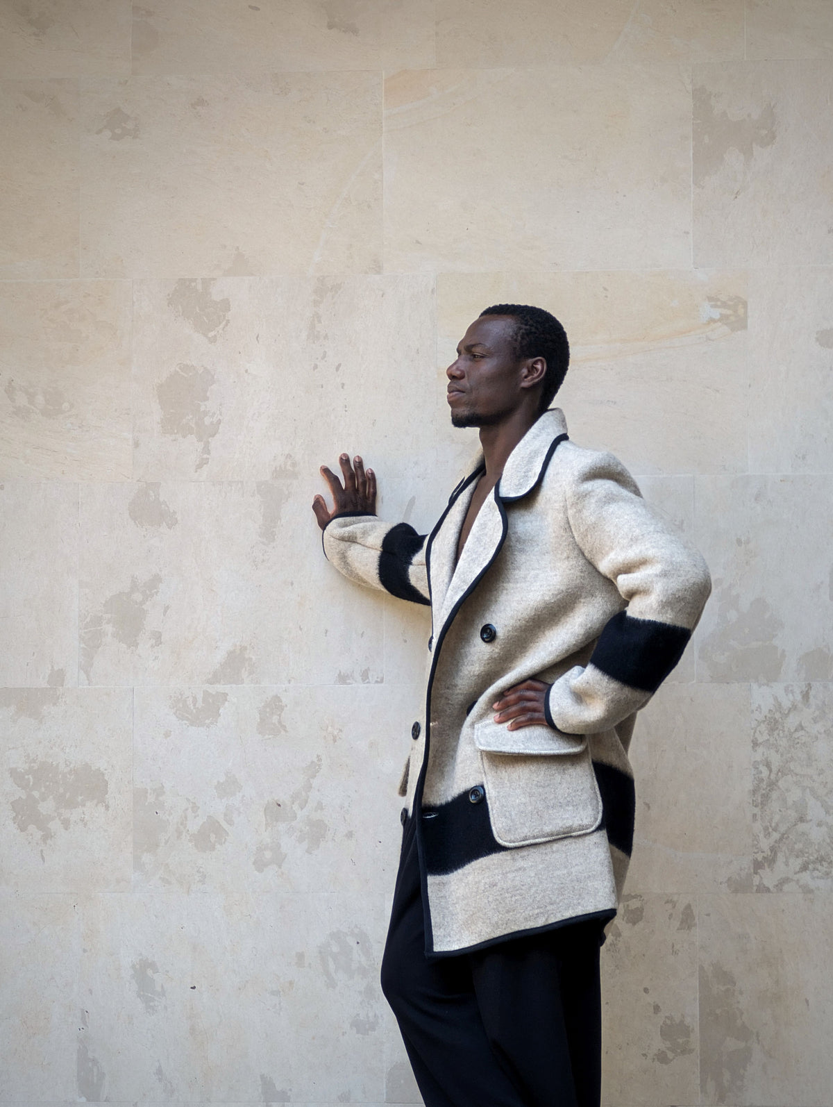 Man wearing a double breasted wool jacket, tailored from a new premium wool handwoven blanket