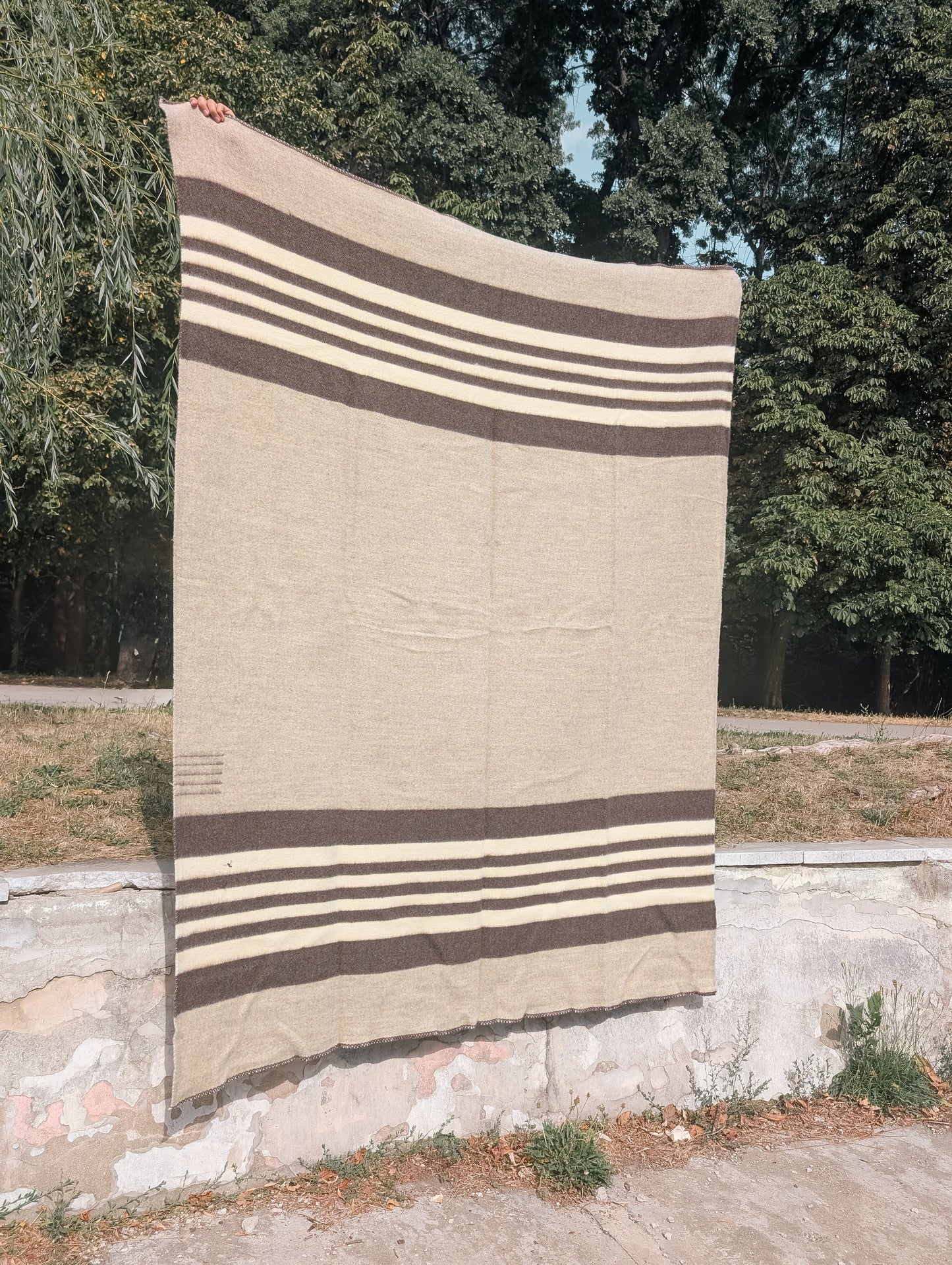 heritage oatmeal wool cabin throw with stripes in earth tones. Traditionally woven and undyed natural sheep's wool blanket.