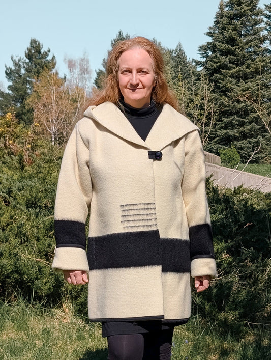 Woman wearing a handcrafted wool swing capote coat, upcycled from sustainable wool blanket 