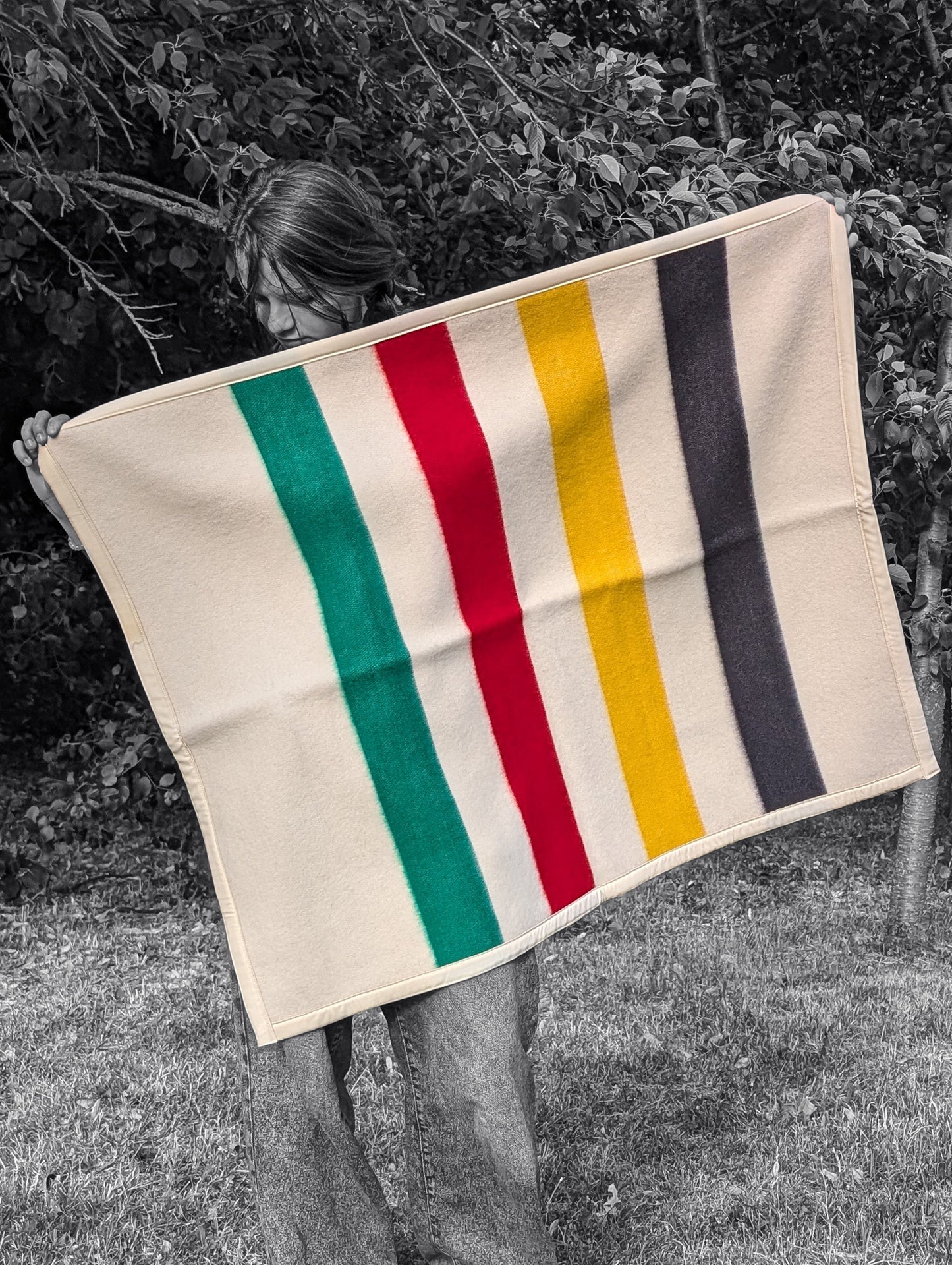 A girl holding a Soft Baby Blanket made from upcycled Lambswool Crib Blanket, B/W photo