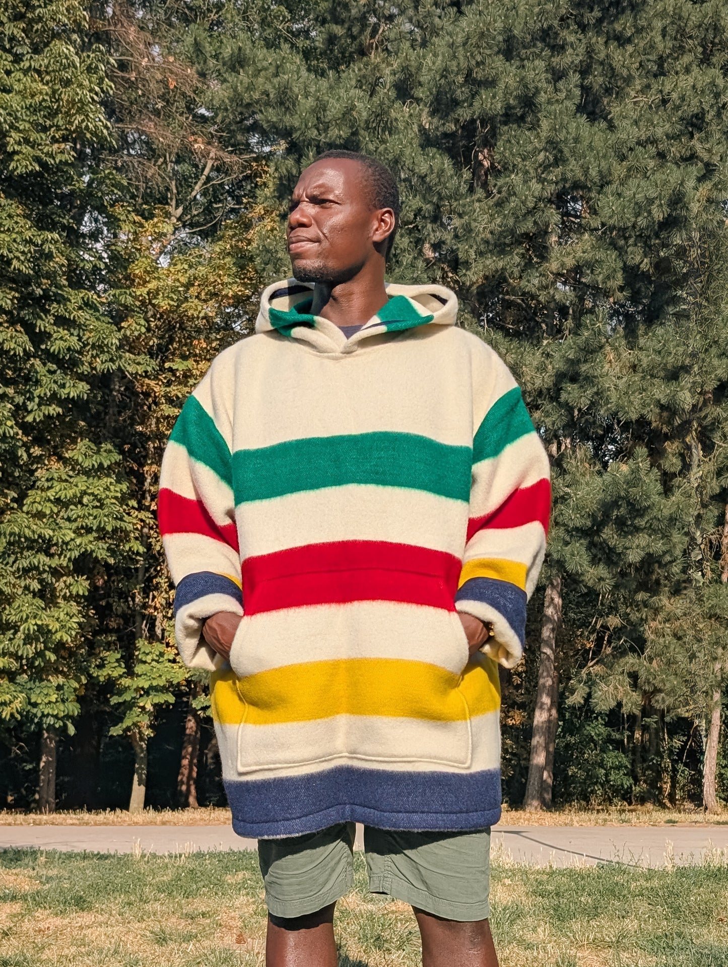 Man wearing a cool modern unisex hooded blanket hoodie with a cangaroo front pocket.
