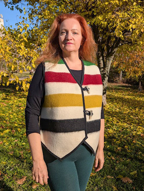 Woman wearing a cool modern colorful vest, upcycled from a new handwoven pure wool blanket.