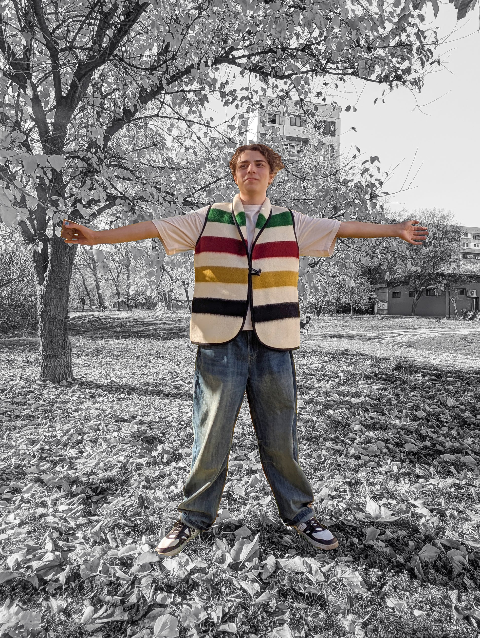 Young man wearing a modern statement unisex candy stripe vest upcycled froma pure wool blanket with ivory base.