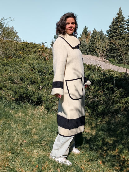 Woman wearing a long cream collar coat with black stripes, made from authentic luxurious wool blanket.
