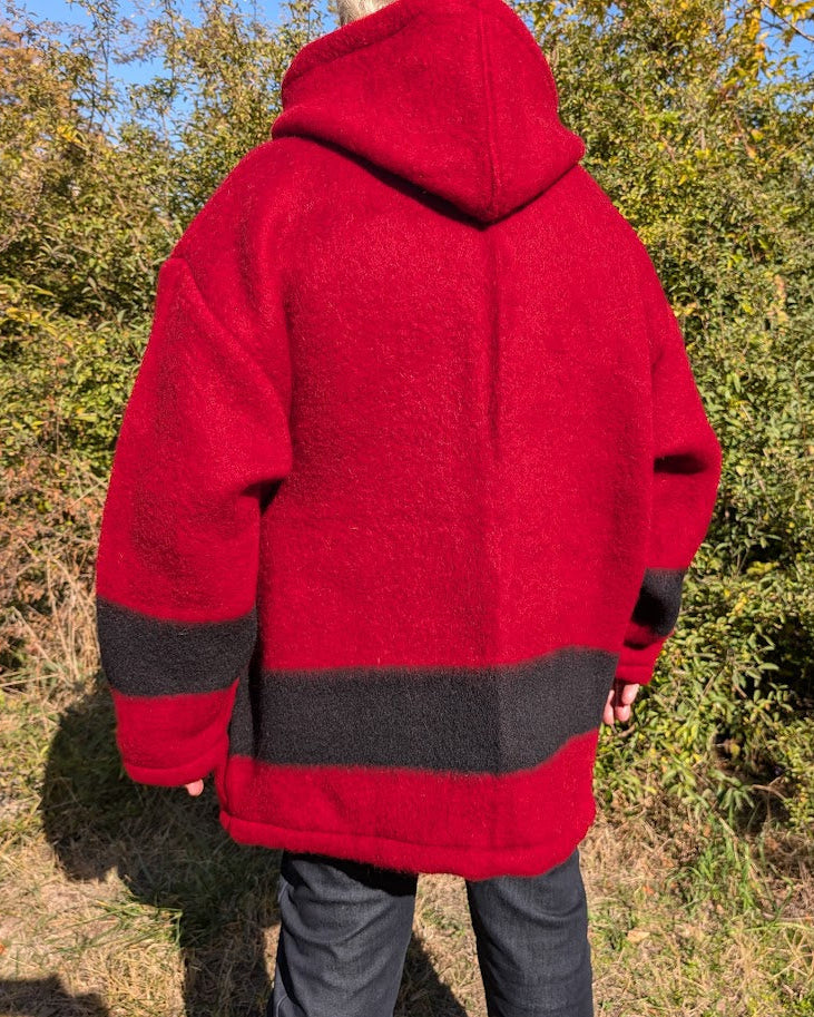 Man wearing a red hoodie anorak made from repurposed red stripe wool blanket.