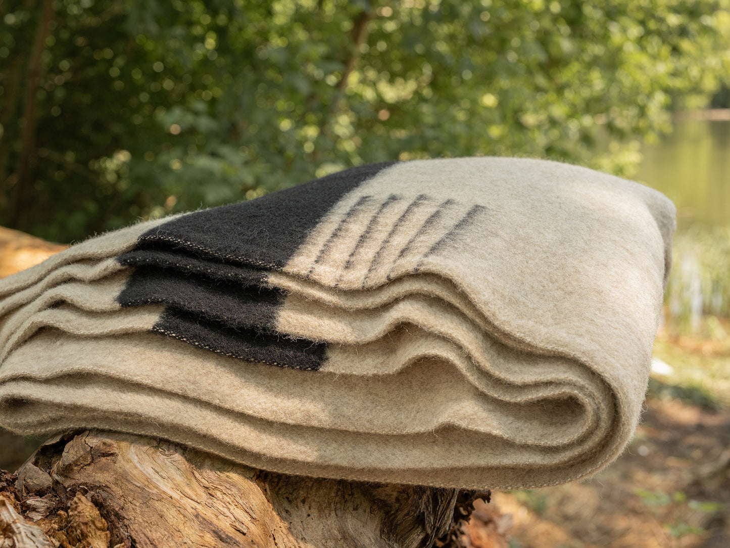 Premium organic blanket in oatmeal gray base with black stripes, handwoven from new natural eco wool.