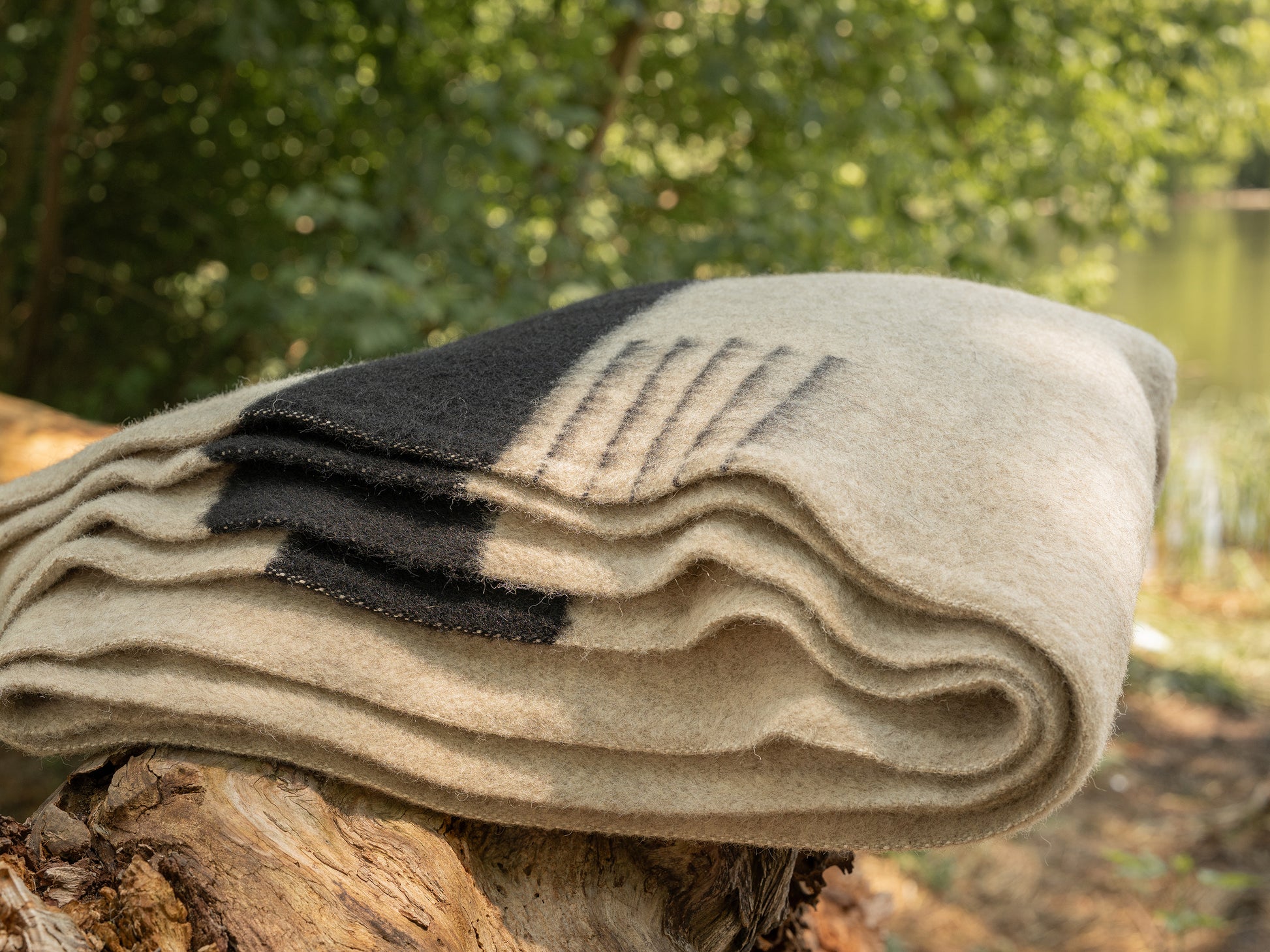 Premium organic blanket in oatmeal gray base with black stripes, handwoven from new natural eco wool.