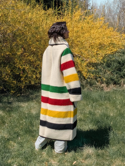 Woman wearing an iconic stripe wool collar coat with wide collar and traditional multicolor stripes
