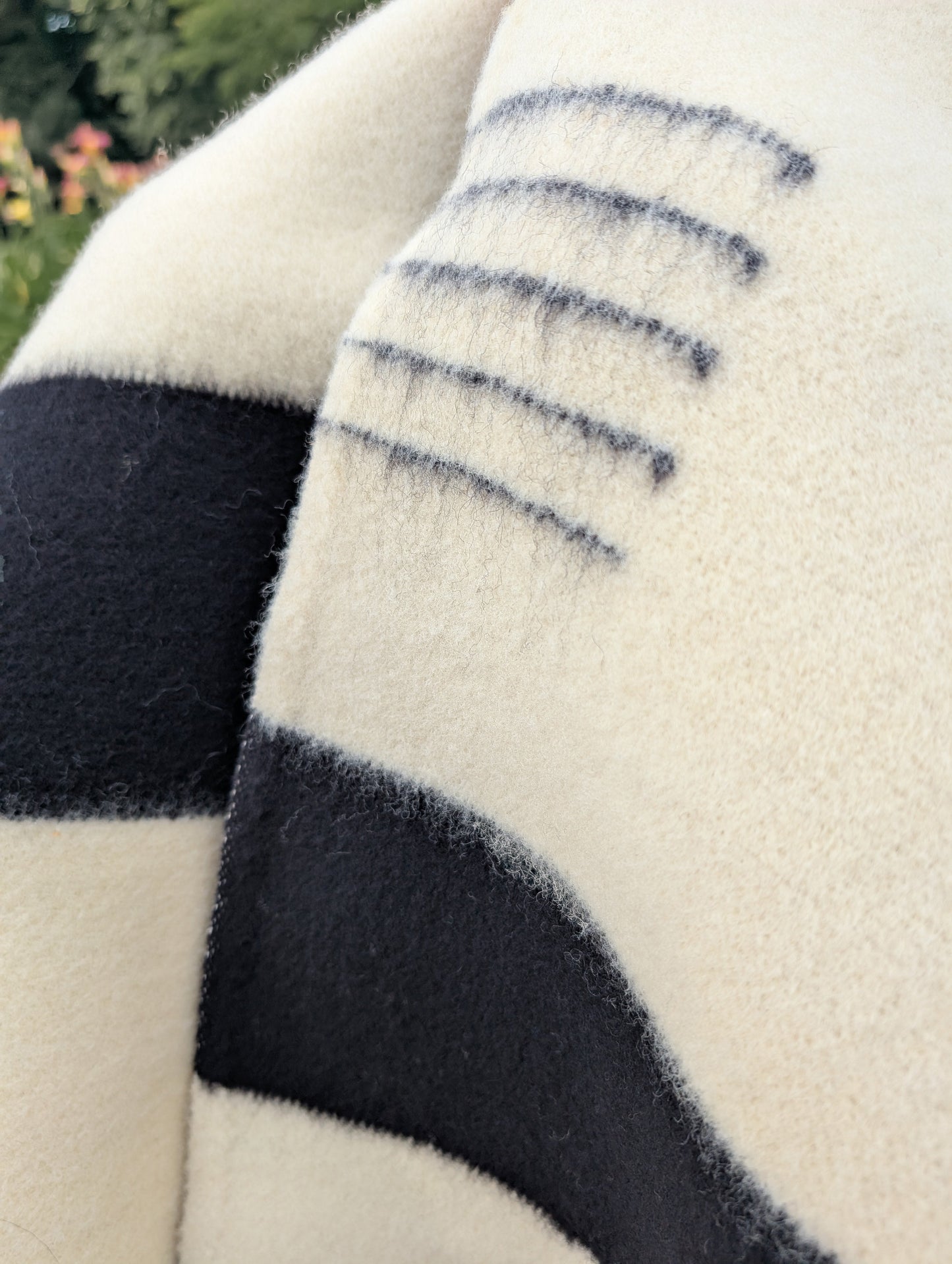 A closeup of an iconic white native frontier wool blanket, handwoven from pure wool