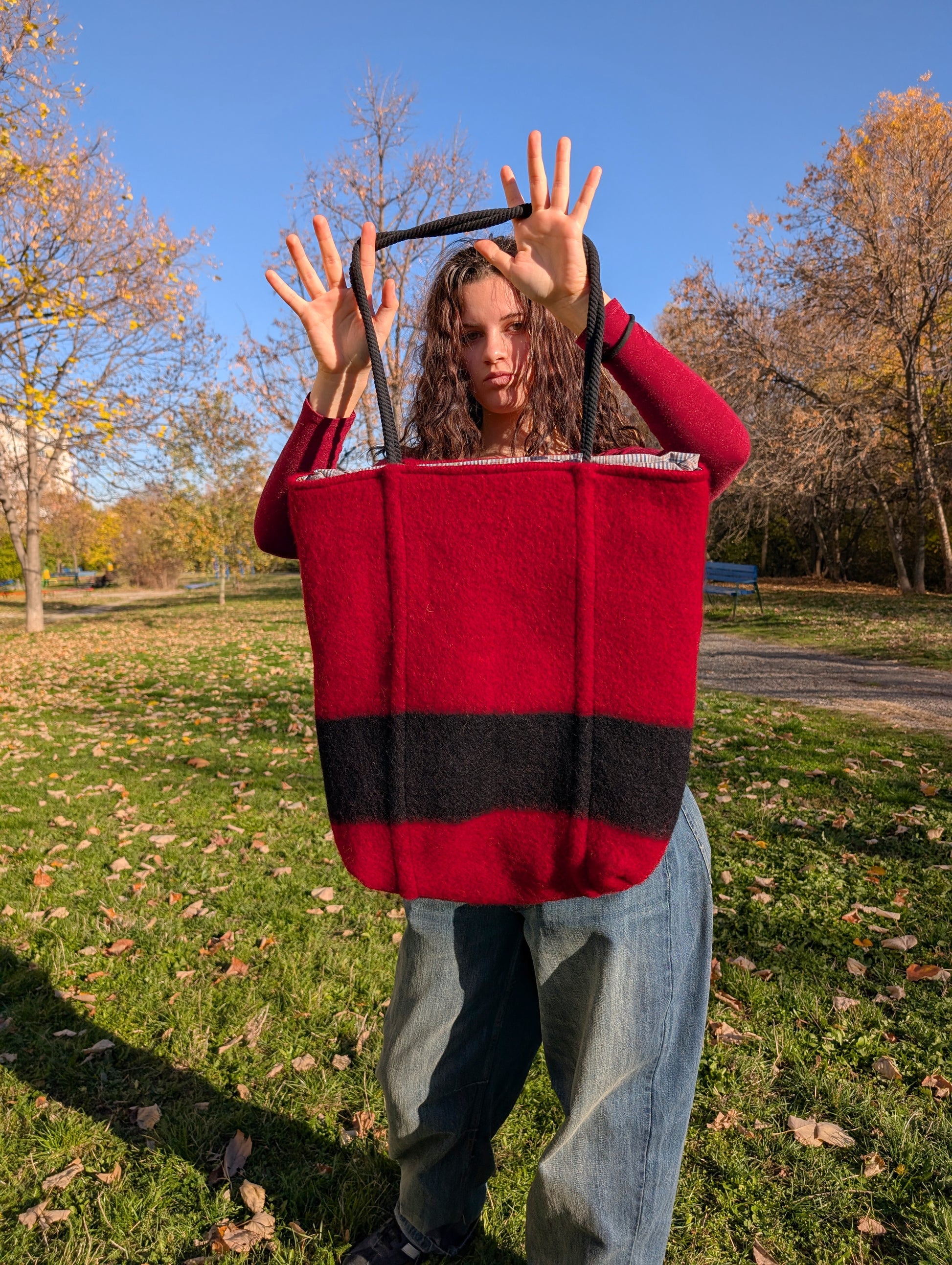 Girl holding a made-to-order large tote bag for all purposes with a pure cotton lining. Original handmade product, upcycled from handcrafted wool blanket. 