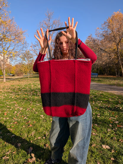 Girl holding a made-to-order large tote bag for all purposes with a pure cotton lining. Original handmade product, upcycled from handcrafted wool blanket. 