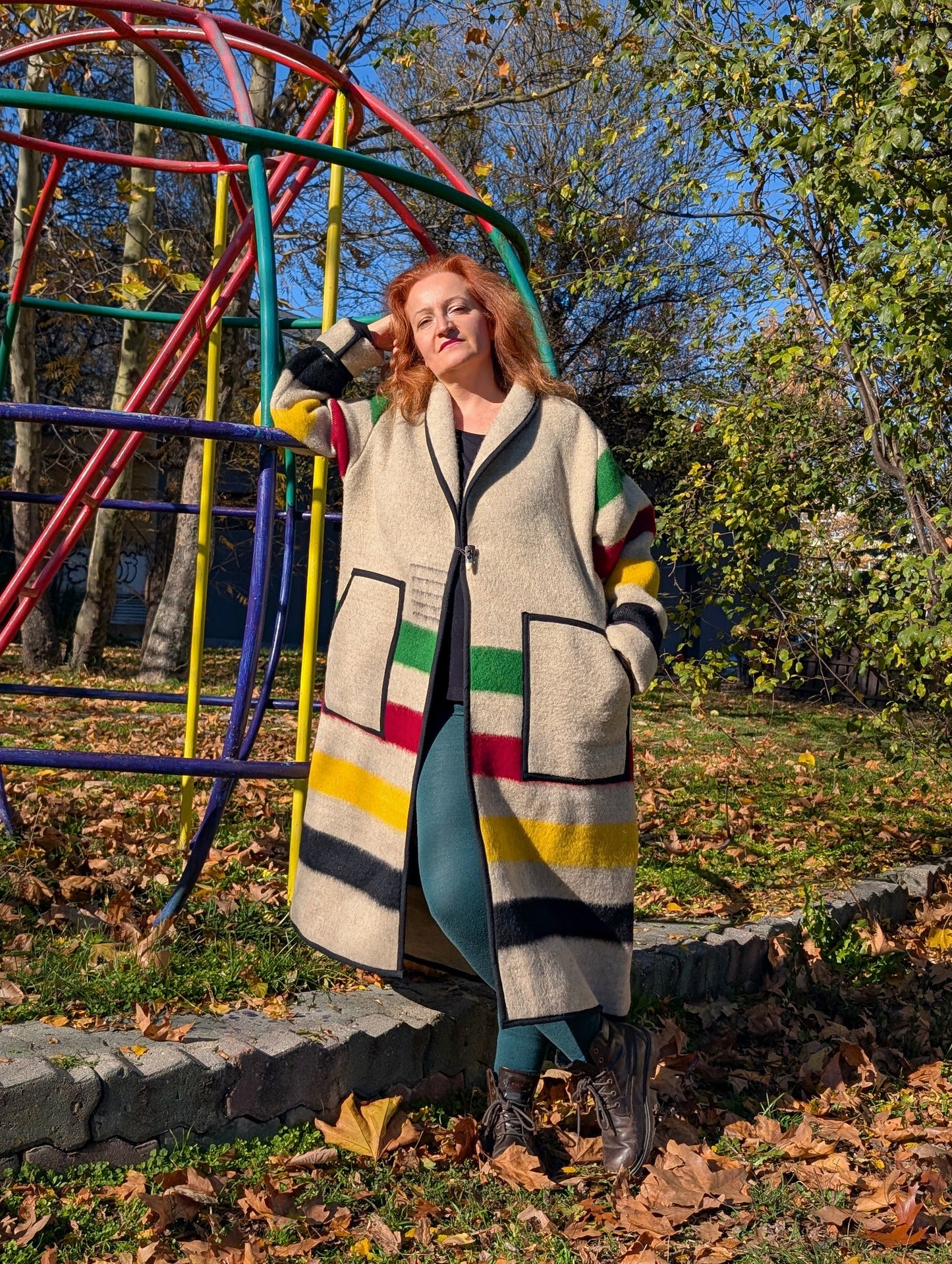 Person wearing a blanket robe coat with iconic heritage stripes