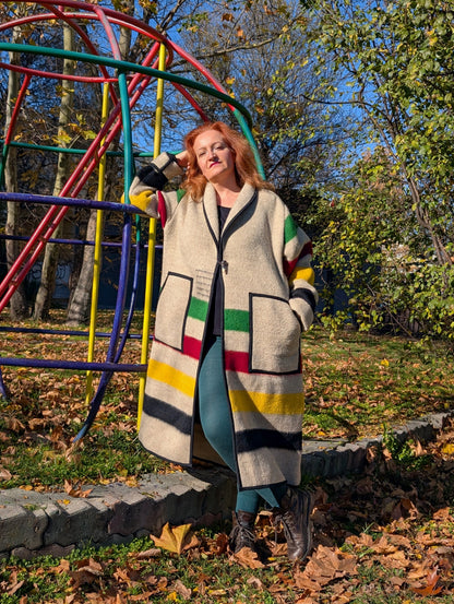 Person wearing a blanket robe coat with iconic heritage stripes