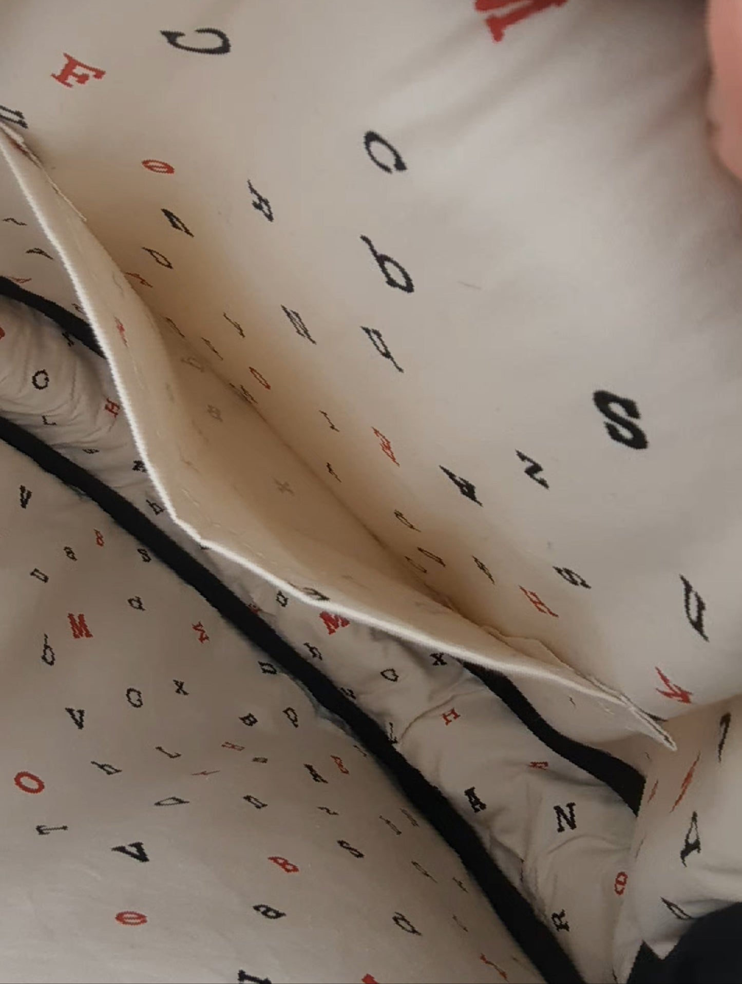 Closeup of a tote bag interior showing a beautiful patterned cotton lining with an inside pocket.