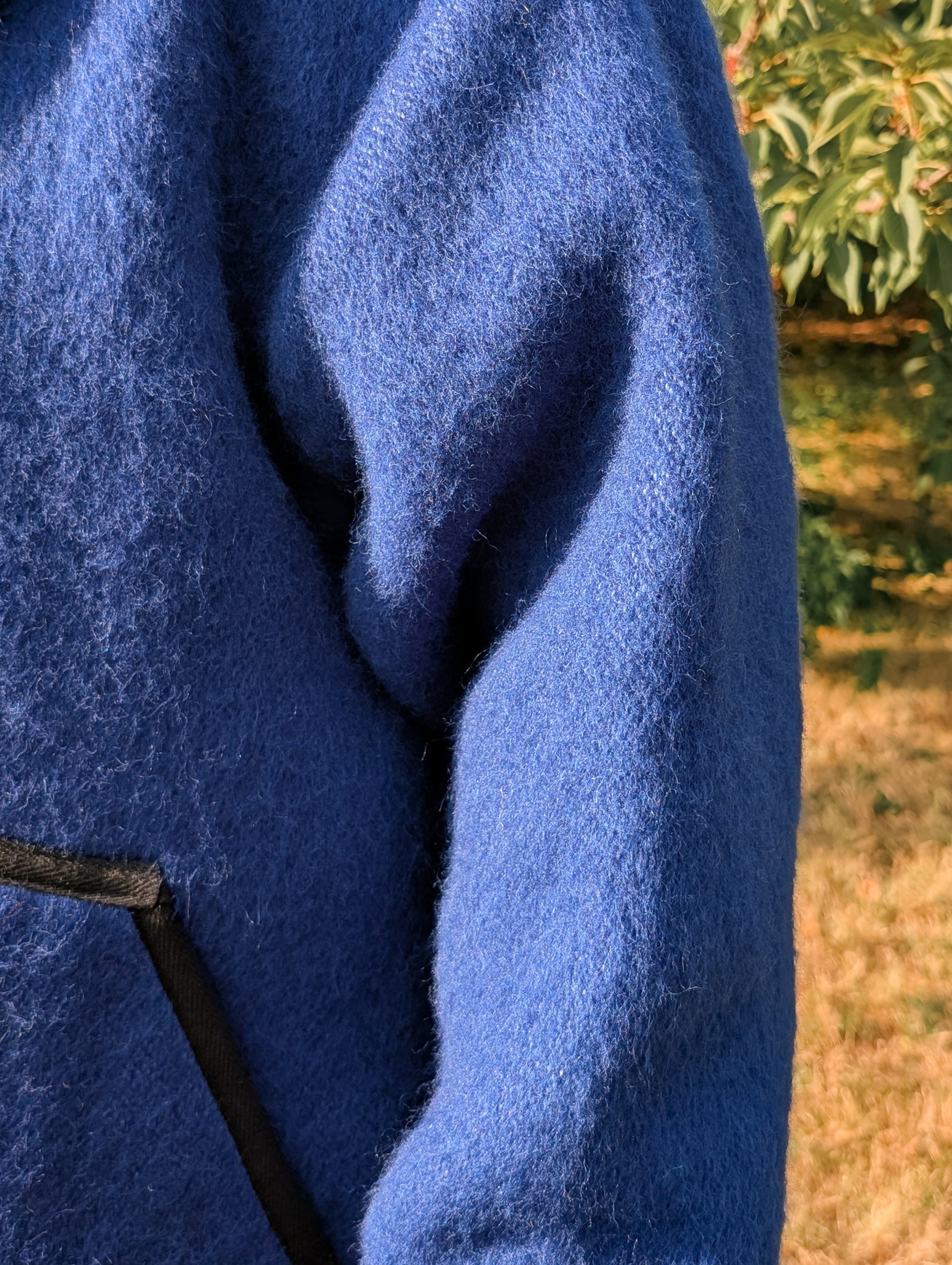 Close-up of a blue woolen texture of an upcycled blanket frontier jacket.