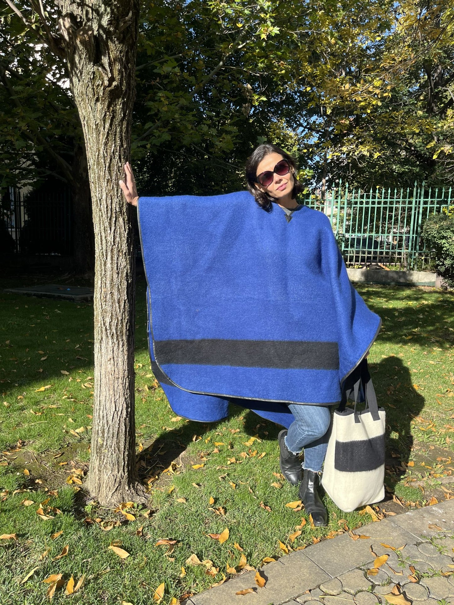 Woman wearing a unisex blanket poncho in iconic heritage style.