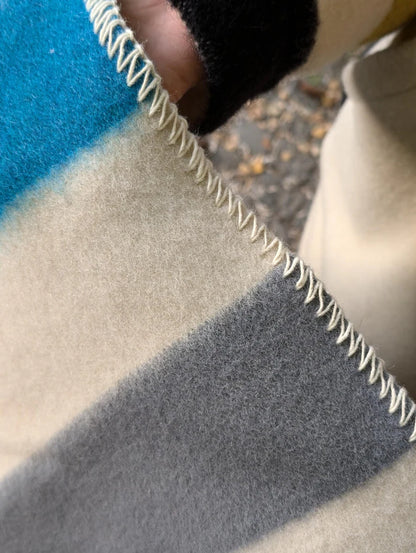 Close-up of a pure wool blanket with a zigzag edge.