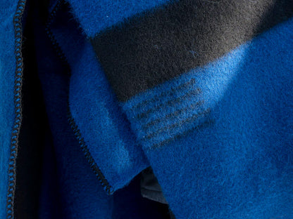 Closeup of am indigenous blue wool balnket with black lines.