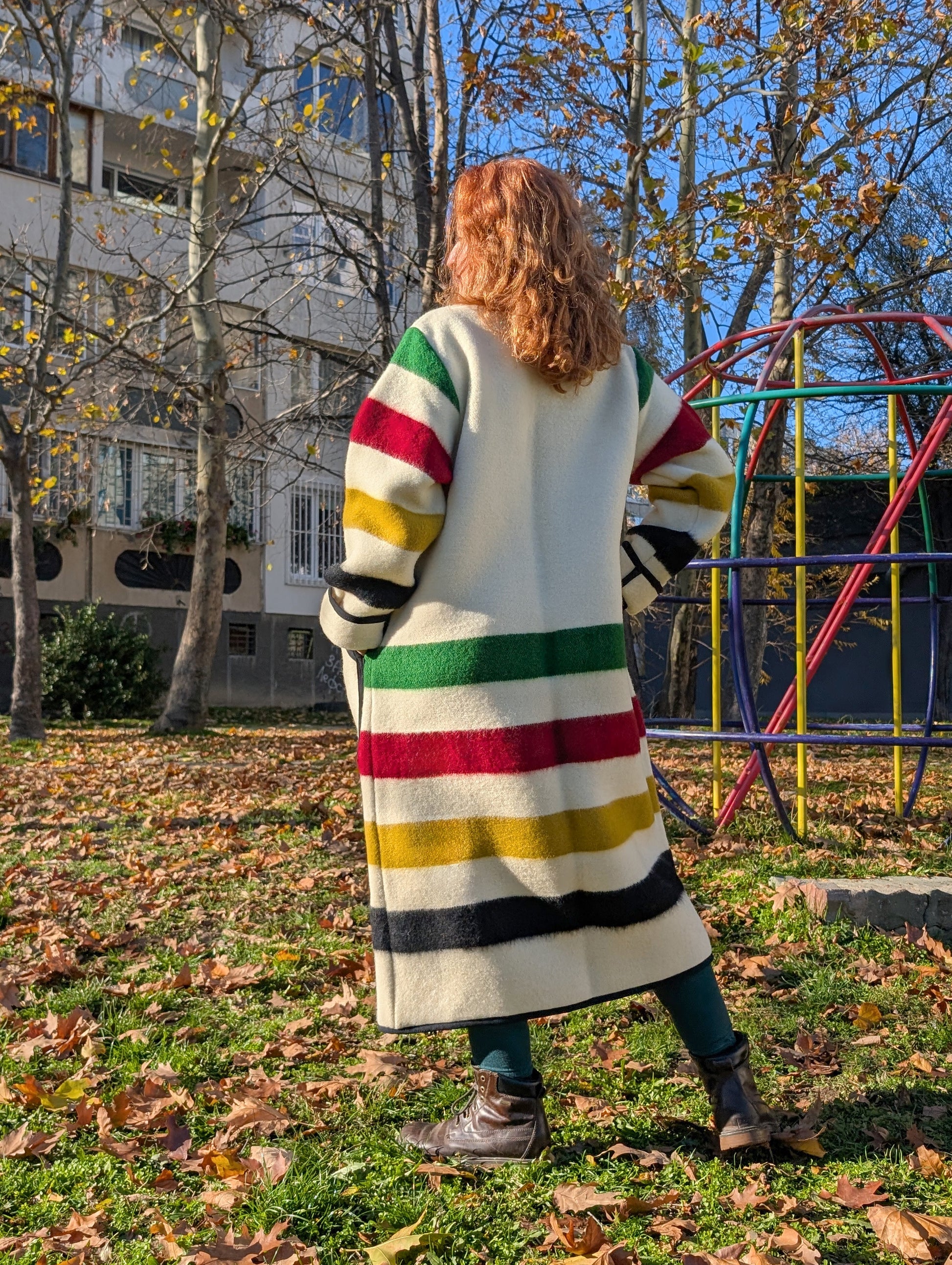 A woman wearing a loose robe coat with shawl collar made from native indigenous wool blanket