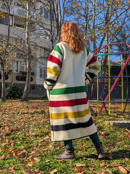 A woman wearing a loose robe coat with shawl collar made from native indigenous wool blanket