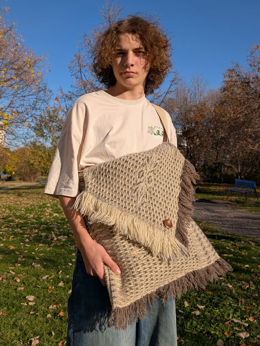 Man wearing a unisex, cross-shoulder large boho bag, made from handwoven structured wool blanket.