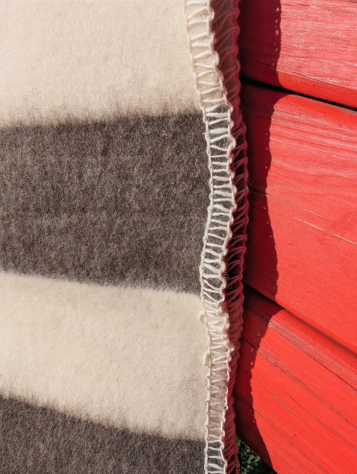 Closeup of a striped throw blanket made of premium 100% pure undyed wool