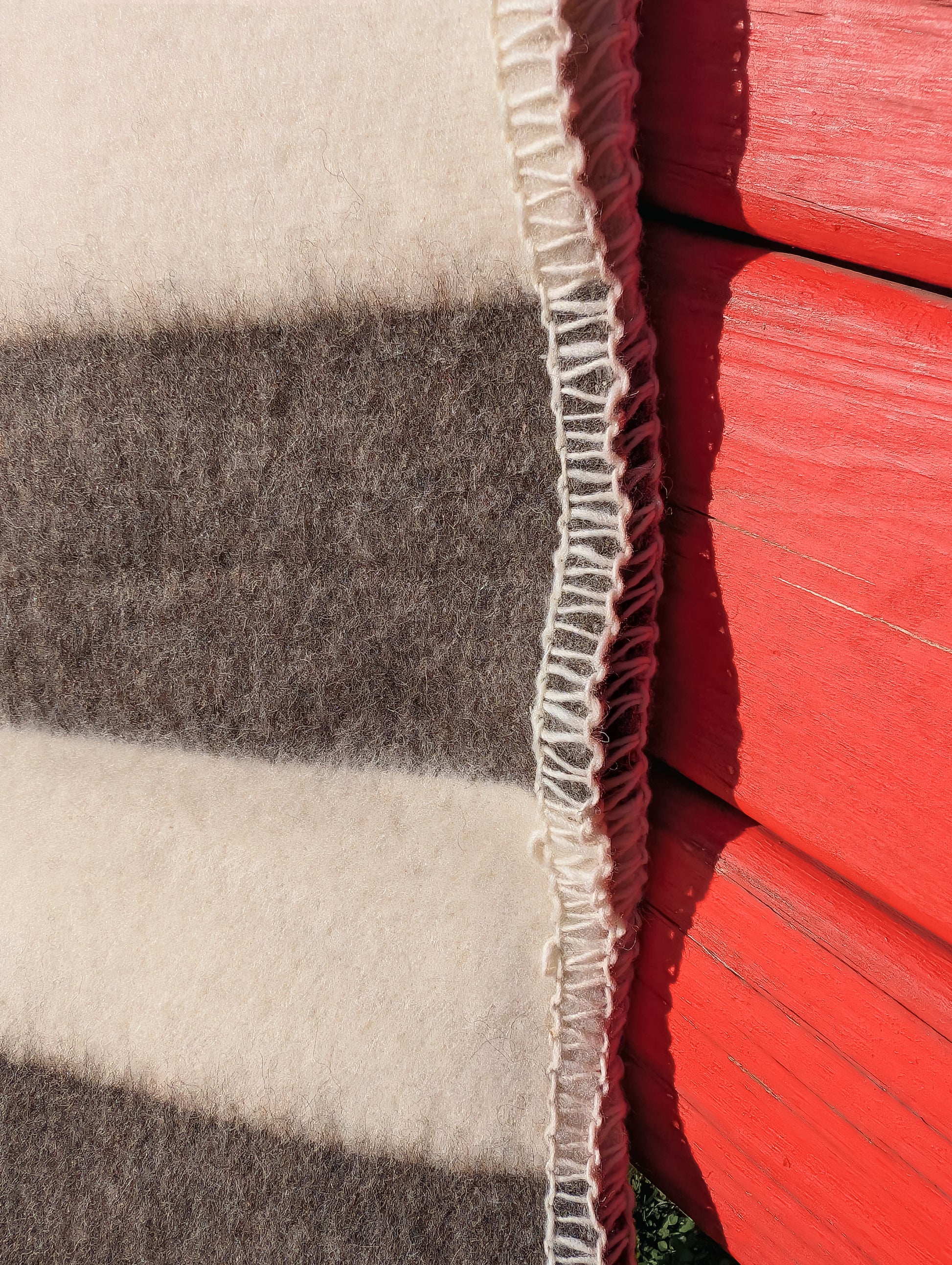 Closeup of a striped throw blanket made of premium 100% pure undyed wool