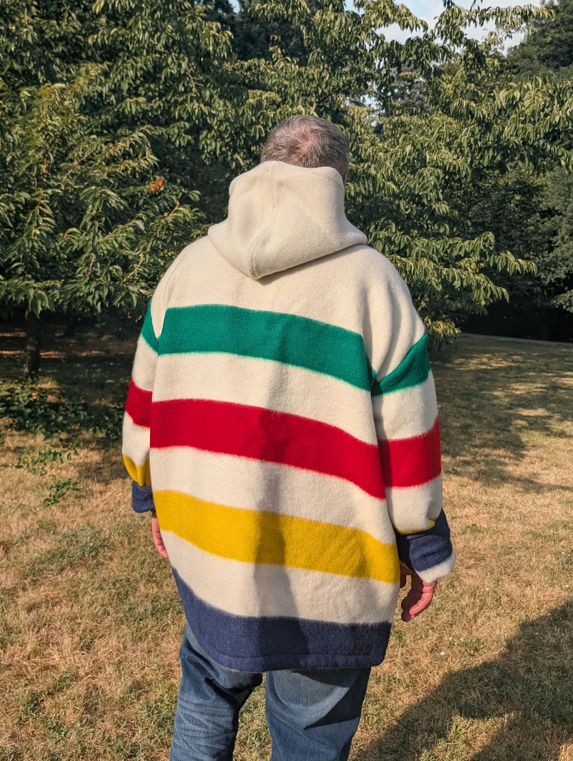Man with a multi striped boho handmade blanket hoodie.