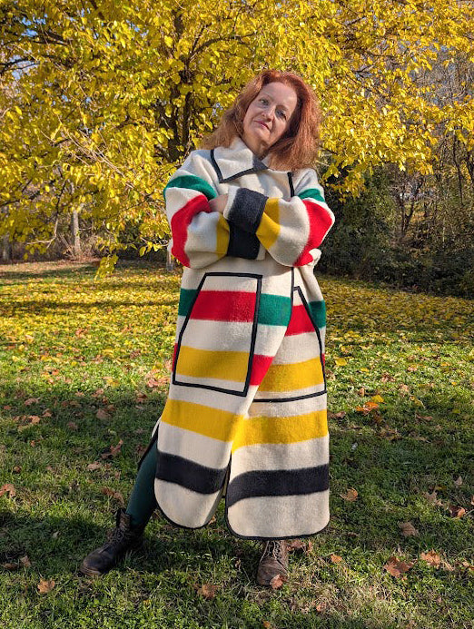 Woman wearing an oversized blanket duster coat handmade and finished in a local family studio.
