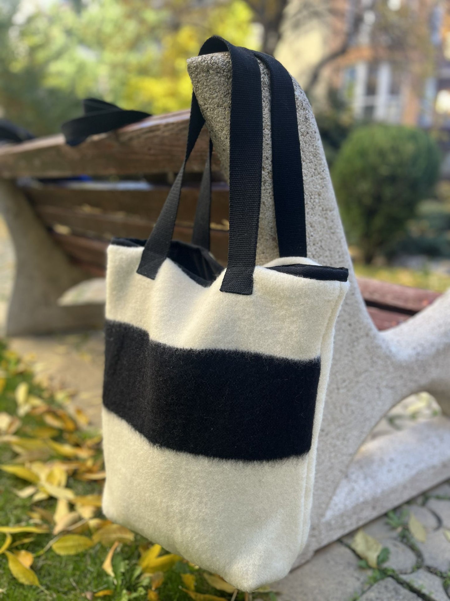 Modern minimalistic slow fashion shoulder bag in ecru, with black stylish accents. Upcycled sustainable handcrafted accessories.