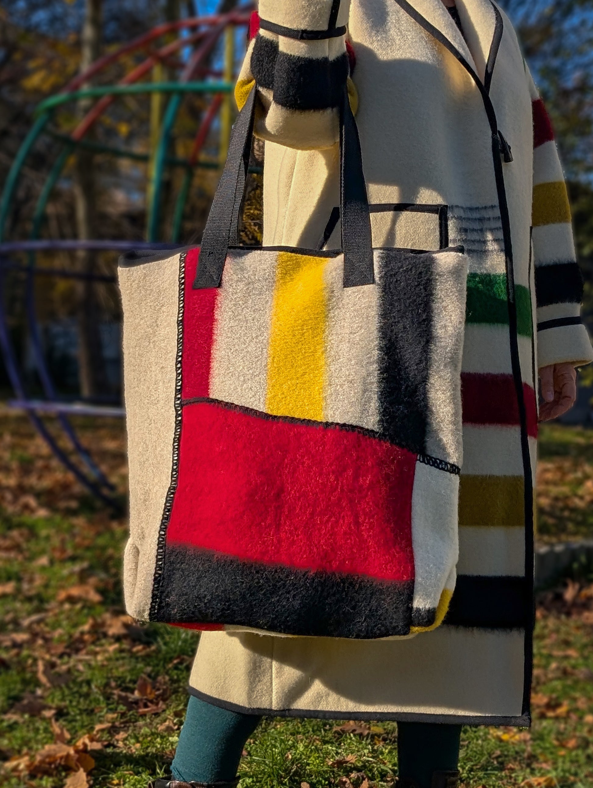 A patchwork geometric design large shopperbag with multiple patches from various pure wool blanket leftovers.