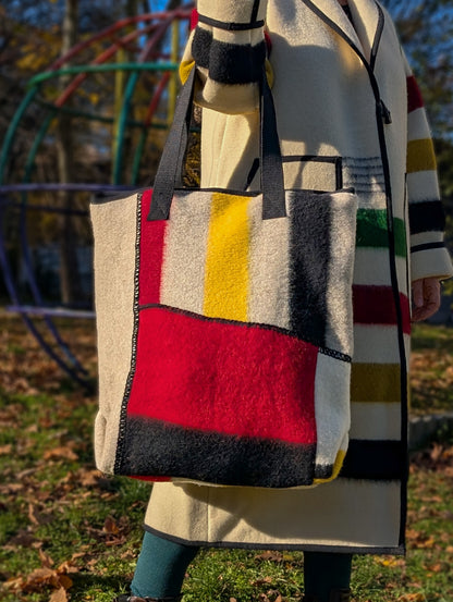 A patchwork geometric design large shopperbag with multiple patches from various pure wool blanket leftovers.