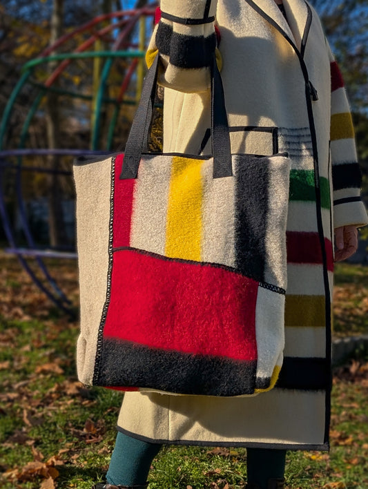 A patchwork geometric design large shopperbag with multiple patches from various pure wool blanket leftovers.