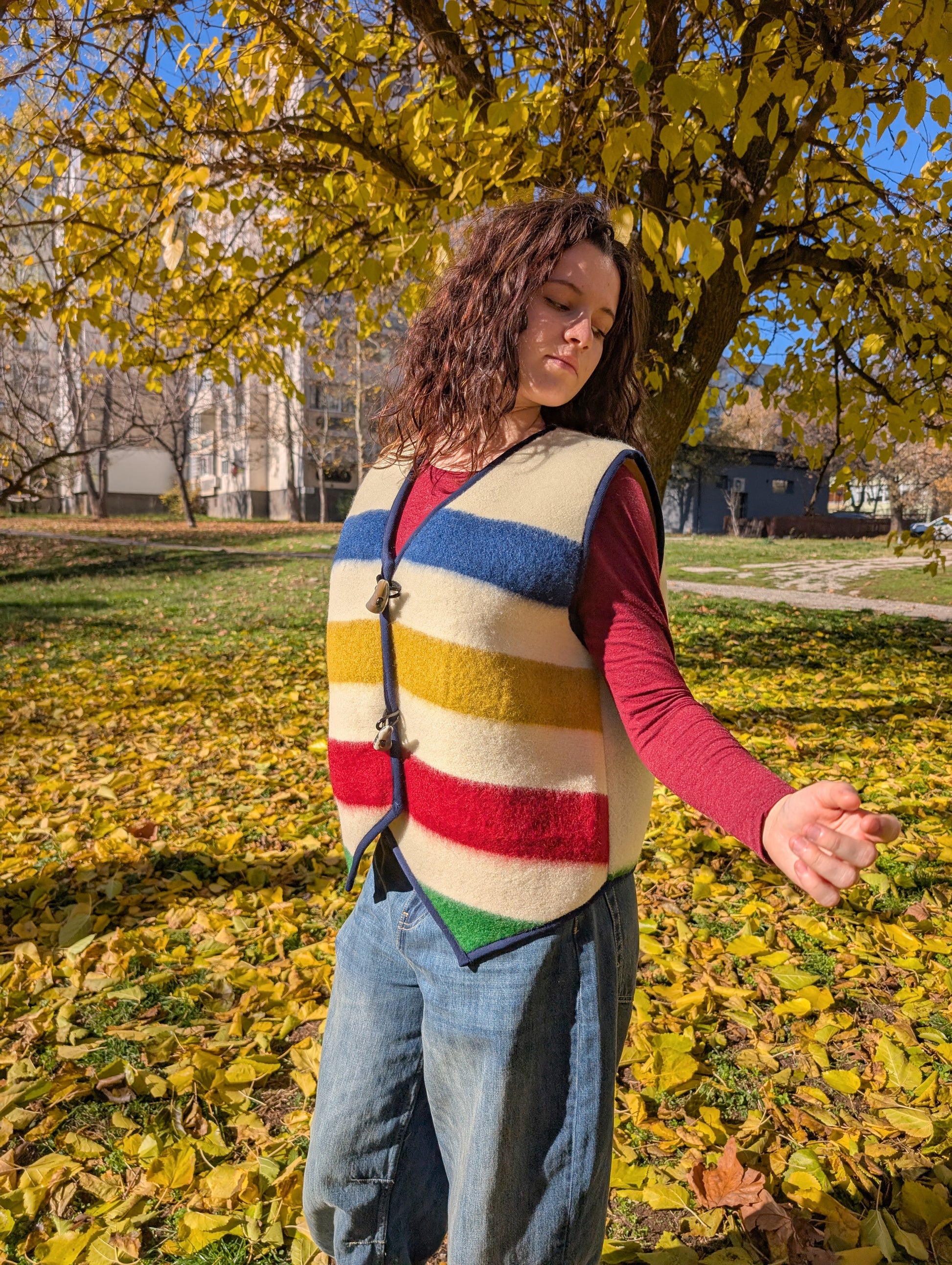 Woman enjoying her beautiful made-to-order comfortable vest with iconic style, featuring traditional ethnic stripes of varied colors and  double toggle horns.