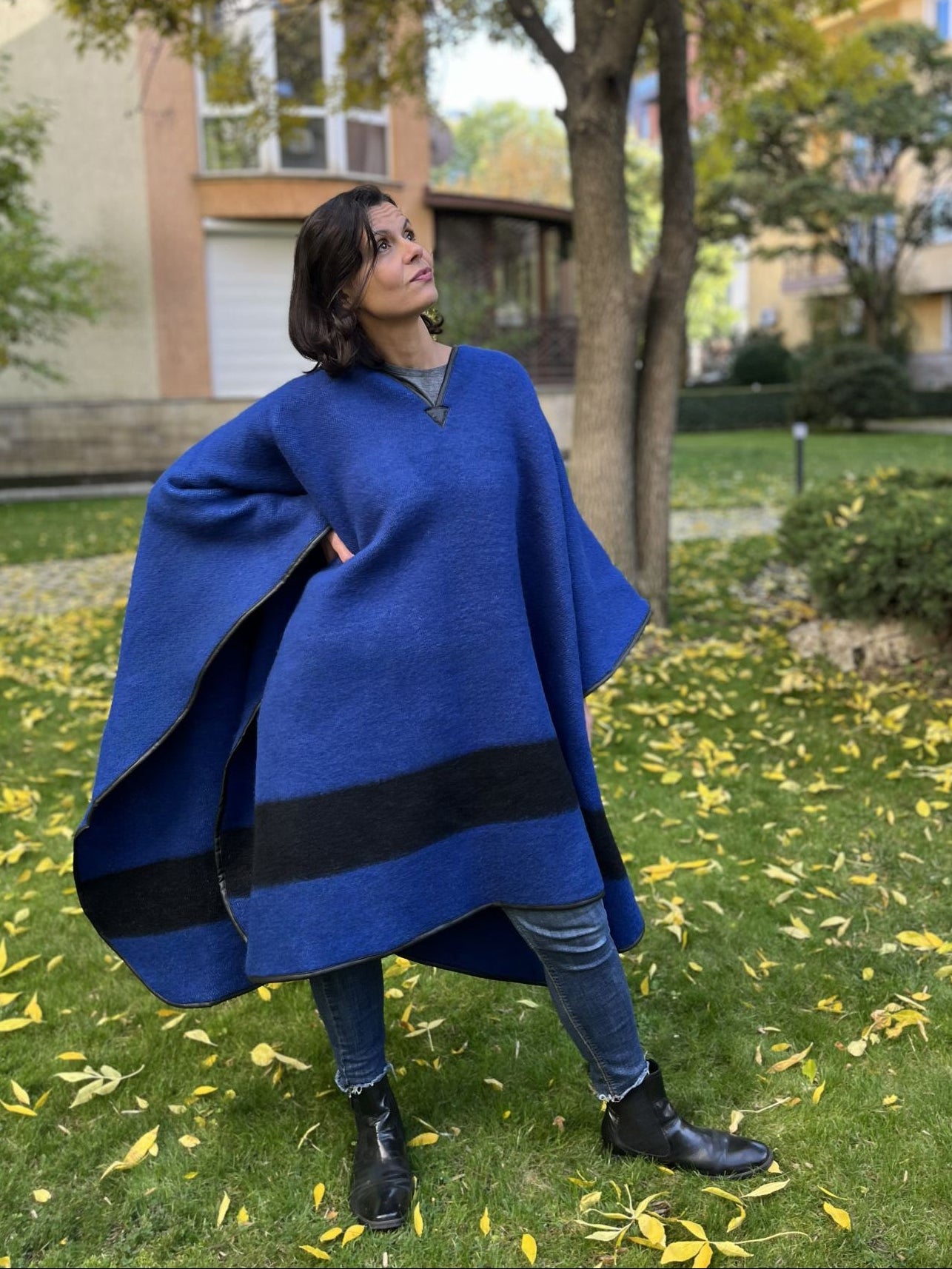 Person wearing an upcycled blue blanket poncho
