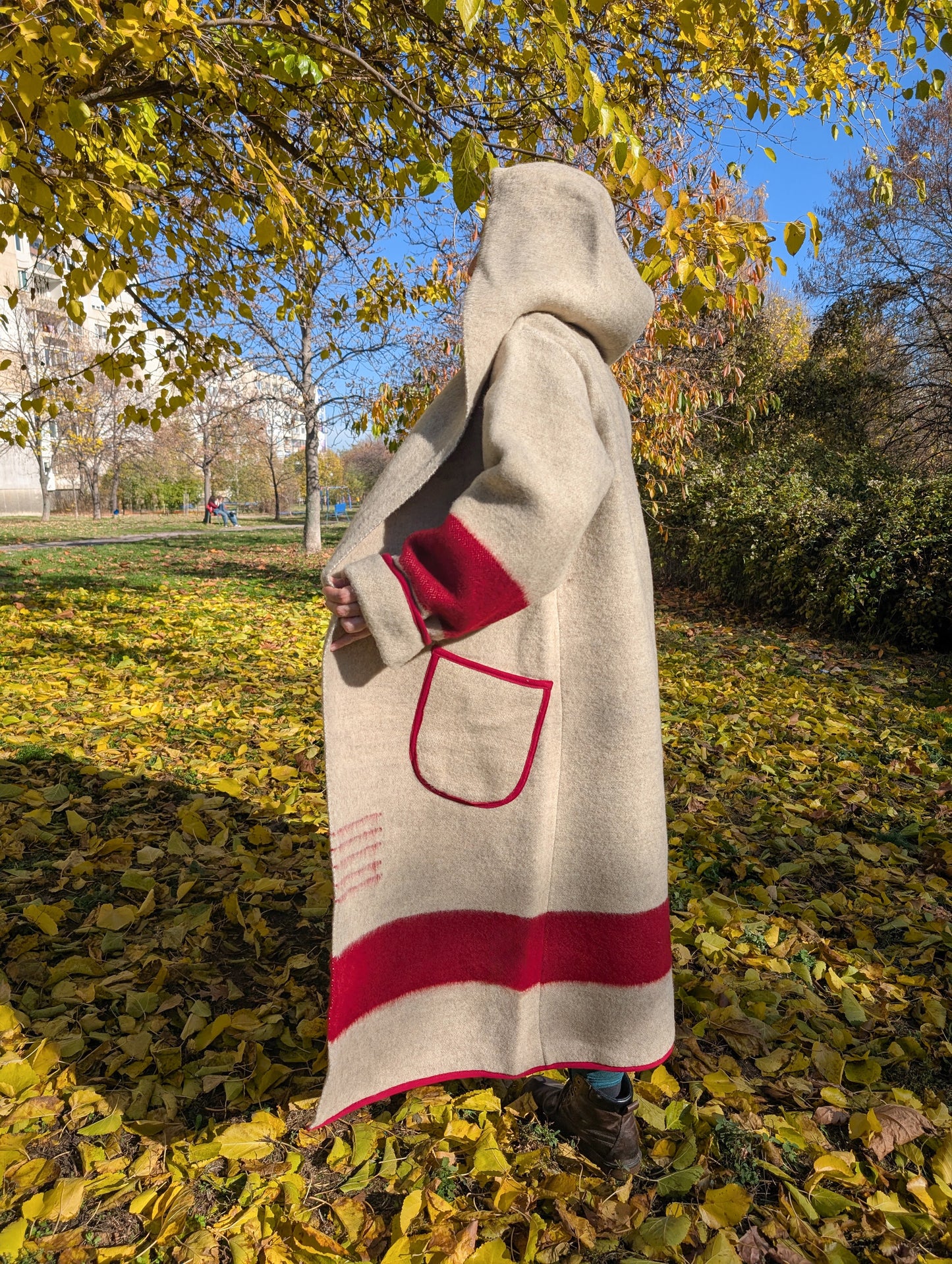 A long hooded wool blanket pioneer coat  with traditional blanket stripes.