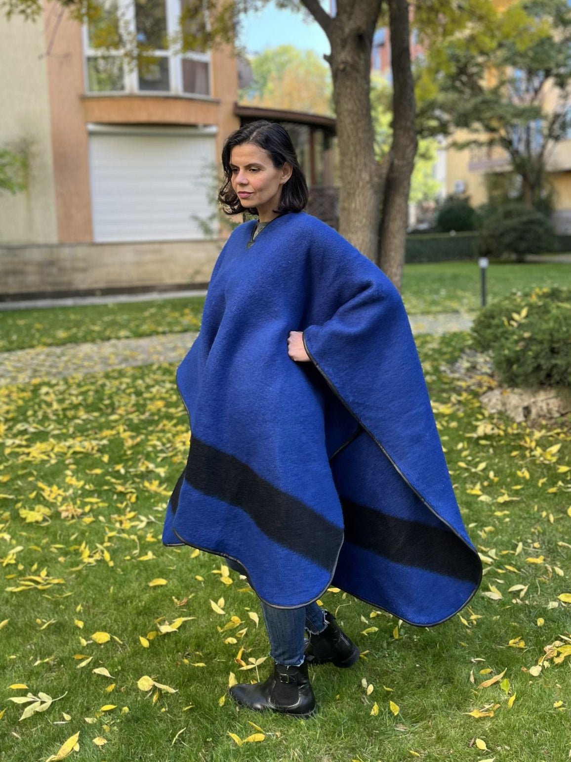 Woman in a blue cape upcycled from blue stripe blanket.