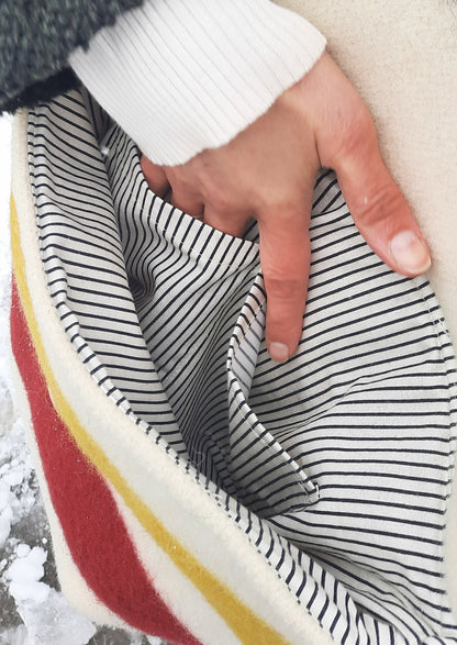 Close-up of a hand showing a high-quality pure cotton interior lining pocket with black and white lines.